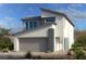 Two-story home showcasing modern architecture with neutral tones, clean lines, and large windows under a bright sky at 10315 Water Knot Ave, Las Vegas, NV 89166