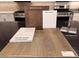 Interior design selection board featuring Simply White quartz, Layton Lake luxury vinyl plank, and Gibson Chrome faucet at 10315 Water Knot Ave, Las Vegas, NV 89166