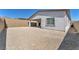 Exterior of home shows covered patio, gravel backyard, and stucco walls at 11707 Hatchling Ave, Las Vegas, NV 89138