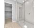Bathroom showcasing the glass walk-in shower with unique tiled walls and entrance to a large walk-in closet at 11707 Hatchling Ave, Las Vegas, NV 89138
