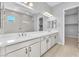 Bright bathroom with a double sink vanity, walk-in glass shower and walk-in closet entrance at 11707 Hatchling Ave, Las Vegas, NV 89138