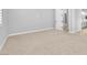 Bedroom featuring neutral carpet and baseboards with open access to the ensuite bathroom at 11707 Hatchling Ave, Las Vegas, NV 89138