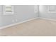 Bright bedroom featuring neutral carpet, baseboards, and shuttered windows allowing for natural light at 11707 Hatchling Ave, Las Vegas, NV 89138