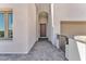 Close-up of a modern home's arched entry with a brick driveway and neutral stucco siding at 11707 Hatchling Ave, Las Vegas, NV 89138