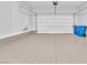 Spacious garage featuring epoxy flooring, high ceilings, and an insulated garage door at 11707 Hatchling Ave, Las Vegas, NV 89138