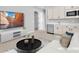 Staged living area boasts a bar with mini fridge, modern furniture, and a wall-mounted TV at 11707 Hatchling Ave, Las Vegas, NV 89138