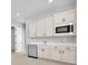 Living area with bar offers white cabinets, stainless steel mini fridge, and microwave at 11707 Hatchling Ave, Las Vegas, NV 89138