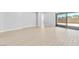 This living room offers sliding glass doors to the backyard and features light wood-style flooring at 11707 Hatchling Ave, Las Vegas, NV 89138
