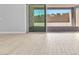 Open sliding glass doors provide access to the back patio, with light wood-style flooring throughout at 11707 Hatchling Ave, Las Vegas, NV 89138