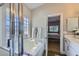 Bright bathroom with separate tub and shower featuring glass block window at 1314 Rossini St, Henderson, NV 89052