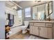 Bathroom featuring a shower over tub, decorative mirror, and vanity with storage at 1314 Rossini St, Henderson, NV 89052