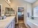 Bright bathroom with separate tub and vanity areas and access to the main bedroom at 1314 Rossini St, Henderson, NV 89052