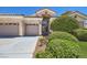 Charming single-story home with mature landscaping, a well-manicured lawn and a spacious three-car garage at 1314 Rossini St, Henderson, NV 89052