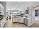 Well-appointed kitchen with white cabinets, stainless appliances, and views into the living area at 1314 Rossini St, Henderson, NV 89052