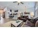Open-concept living room with modern decor, tile floors, and abundant natural light at 1314 Rossini St, Henderson, NV 89052