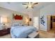 This main bedroom offers a ceiling fan, neutral paint, and adjacent ensuite bath and walk-in closet at 1314 Rossini St, Henderson, NV 89052