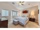 Serene main bedroom with neutral tones, a ceiling fan, and a large window at 1314 Rossini St, Henderson, NV 89052