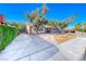 Charming single-story brick home with mature trees, circular driveway, and well-maintained landscaping at 1721 E Oakey Blvd, Las Vegas, NV 89104