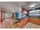 Open kitchen offers a gas cooktop, custom cabinets, and seamless transition to the living area with hardwood floors at 1721 E Oakey Blvd, Las Vegas, NV 89104