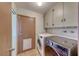 Convenient laundry room featuring a side-by-side washer and dryer and upper cabinets at 1721 E Oakey Blvd, Las Vegas, NV 89104