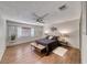 Comfortable main bedroom with wood-look tile floors, a ceiling fan, and natural light from the window at 1721 E Oakey Blvd, Las Vegas, NV 89104