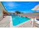Backyard featuring pool and a brick outdoor fireplace at 1721 E Oakey Blvd, Las Vegas, NV 89104