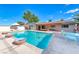 Gorgeous backyard pool with covered patio and lounge area, surrounded by a privacy fence for outdoor enjoyment at 1721 E Oakey Blvd, Las Vegas, NV 89104