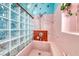Vintage bathroom with pink tile, glass block wall, and showerhead with a tiled niche at 1721 E Oakey Blvd, Las Vegas, NV 89104