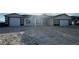 Charming single-story home with a symmetrical facade, featuring a gravel driveway and a two-car garage on each side at 1760 Omaha Ave, Pahrump, NV 89048