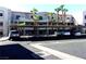 Apartment building featuring covered parking, palm trees, and modern architecture, perfect for convenient living at 2044 Mesquite Ln # 301, Laughlin, NV 89029
