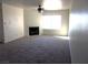 Spacious living room with a cozy fireplace and ceiling fan, perfect for relaxation and comfort at 2044 Mesquite Ln # 301, Laughlin, NV 89029