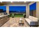 Inviting back patio with an outdoor kitchen and comfortable seating, perfect for evening relaxation and entertainment at 2246 Bird Of Prey St, Las Vegas, NV 89138