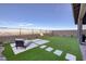 Fenced backyard with turf and lounge seating offers great privacy and relaxation with distant views at 2246 Bird Of Prey St, Las Vegas, NV 89138
