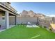 Beautiful backyard featuring artificial turf, lounge seating, and mountain views, ideal for outdoor enjoyment at 2246 Bird Of Prey St, Las Vegas, NV 89138