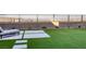 Turf backyard featuring lounge seating and desert views is perfect for low maintenance at 2246 Bird Of Prey St, Las Vegas, NV 89138
