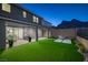 Beautiful backyard with artificial turf, covered patio, desert landscape, grill and mountain views at 2246 Bird Of Prey St, Las Vegas, NV 89138