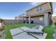 Spacious backyard featuring artificial turf, stylish lounge seating, and lush landscaping, perfect for relaxation at 2246 Bird Of Prey St, Las Vegas, NV 89138