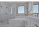 Modern bathroom featuring a glass enclosed shower and soaking tub at 2246 Bird Of Prey St, Las Vegas, NV 89138