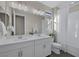 Bright bathroom with dual sink vanity, large mirror, and a shower-tub combination at 2246 Bird Of Prey St, Las Vegas, NV 89138