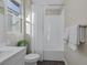 Bathroom featuring a tub with white tile surround, toilet, and neutral walls at 2246 Bird Of Prey St, Las Vegas, NV 89138