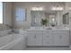Luxurious bathroom featuring double sinks and a soaking tub at 2246 Bird Of Prey St, Las Vegas, NV 89138