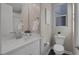 Cozy bathroom features a white vanity, toilet, and natural light from a window at 2246 Bird Of Prey St, Las Vegas, NV 89138
