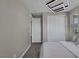 Bedroom with gray carpeting, modern light fixture, and a large walk-in closet at 2246 Bird Of Prey St, Las Vegas, NV 89138