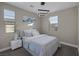 This bedroom features an abstract light fixture, neutral colors, and dual windows at 2246 Bird Of Prey St, Las Vegas, NV 89138