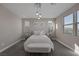 Bright bedroom with soft carpet, stylish lighting, and mountain views through the large windows at 2246 Bird Of Prey St, Las Vegas, NV 89138