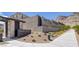 View of Osprey Ridge community entrance with lush landscaping and desert surroundings at 2246 Bird Of Prey St, Las Vegas, NV 89138