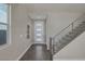 Inviting foyer with staircase, modern design, neutral paint, tile floors and lots of natural light at 2246 Bird Of Prey St, Las Vegas, NV 89138