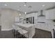 Elegant kitchen with white cabinetry, stainless steel appliances, and a central island at 2246 Bird Of Prey St, Las Vegas, NV 89138
