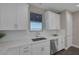 Bright kitchen features white cabinets, stainless steel appliances, and a window offering natural light at 2246 Bird Of Prey St, Las Vegas, NV 89138
