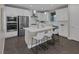 Modern white kitchen featuring stainless steel appliances and a central island with seating at 2246 Bird Of Prey St, Las Vegas, NV 89138